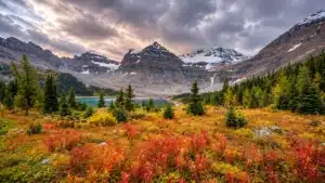 Rocky mountains and an alpine lake under dramatic autumn clouds