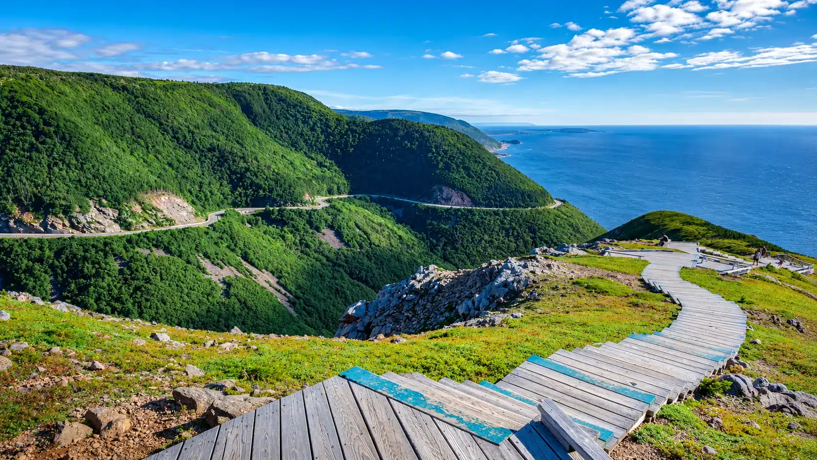 Boardwalk trail above a winding coastal highway and the ocean